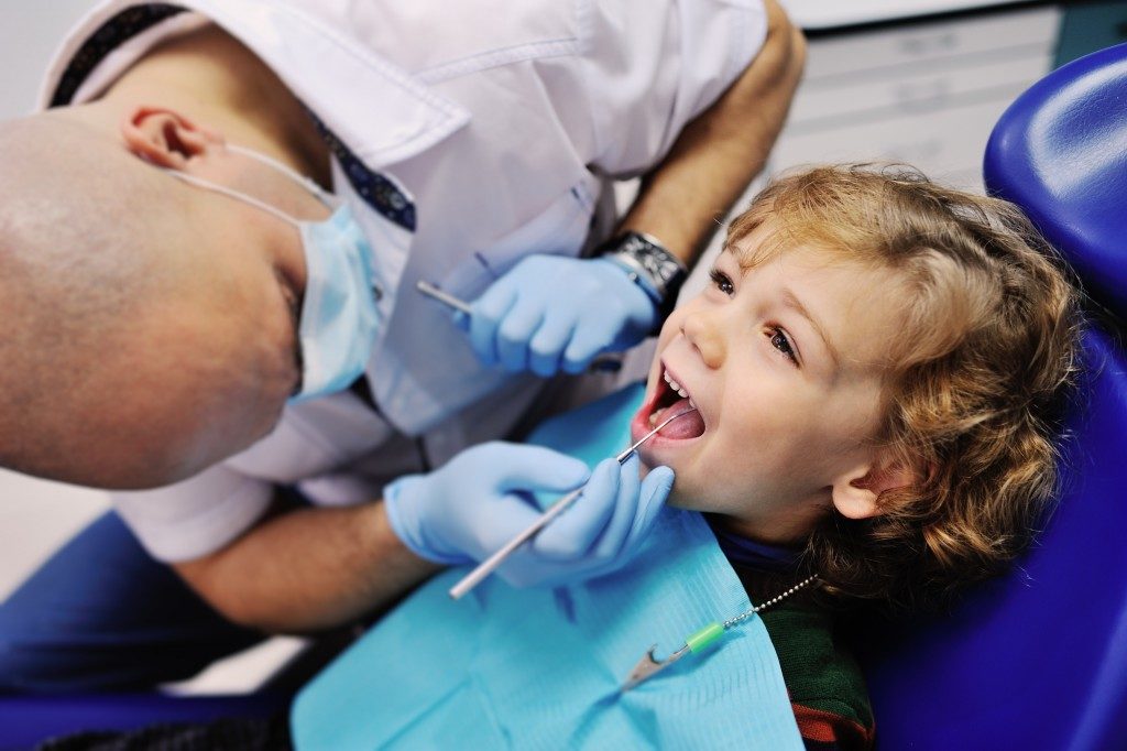 Dentist checking a child's teeth