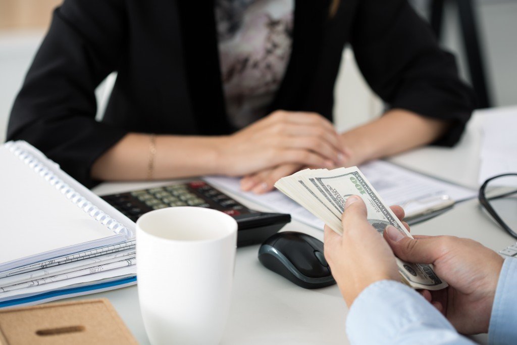 Bank employee holding money