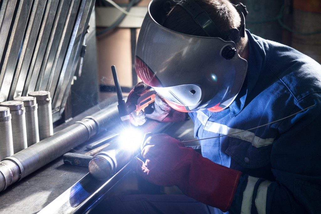 worker welding a pipe