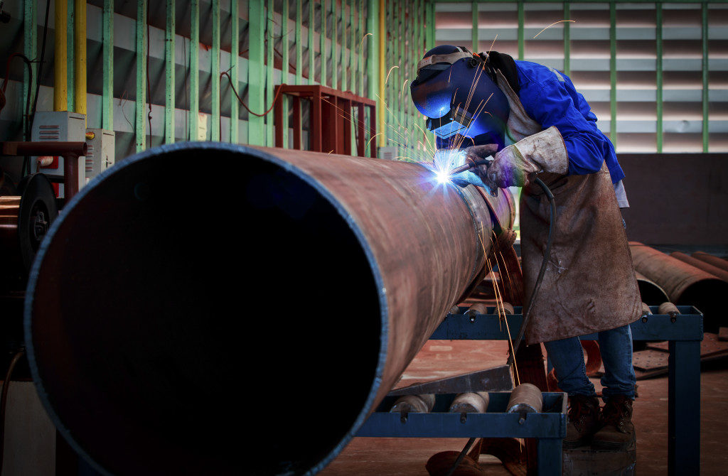 worker welding a pipe