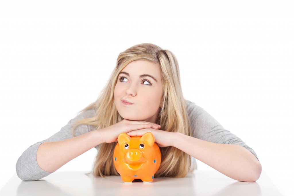 young woman and her piggy bank