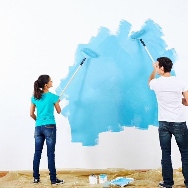 couple painting new home together