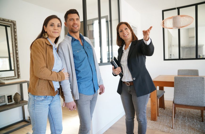 open house with female real estate agent talking to an interested couple