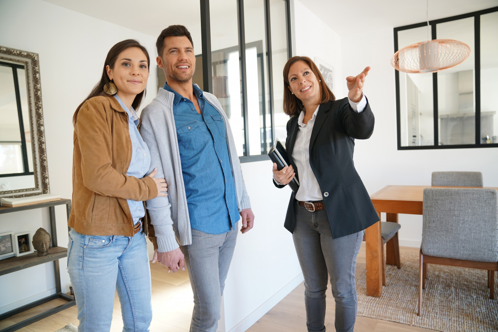 open house with female real estate agent talking to an interested couple