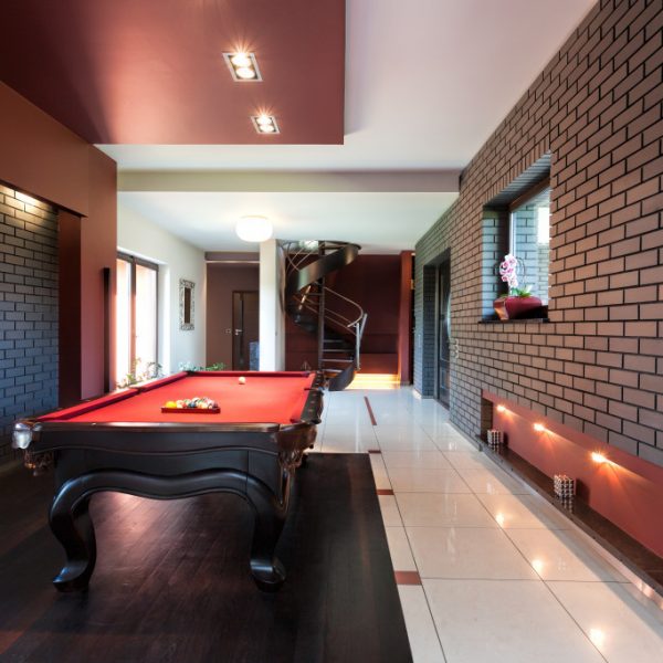 renovated basement with a game table in the middle