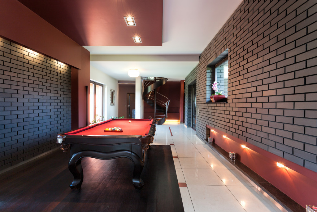 renovated basement with a game table in the middle
