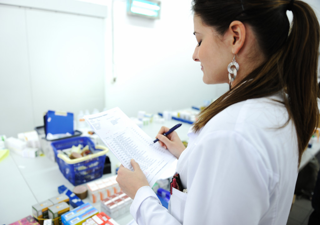 woman performing hospital inspection with paper checklist