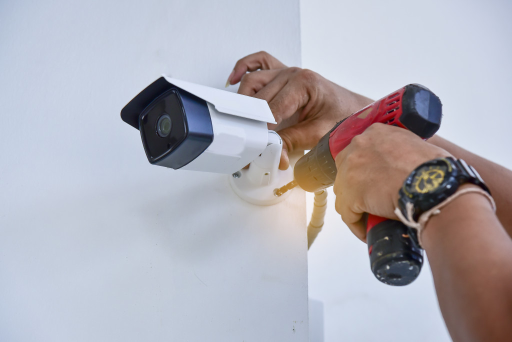 person with surveillance camera installed
